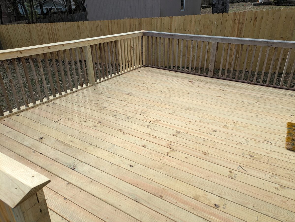 Fresh pressure-treated wood deck with wood baluster railing, Northwest Arkansas